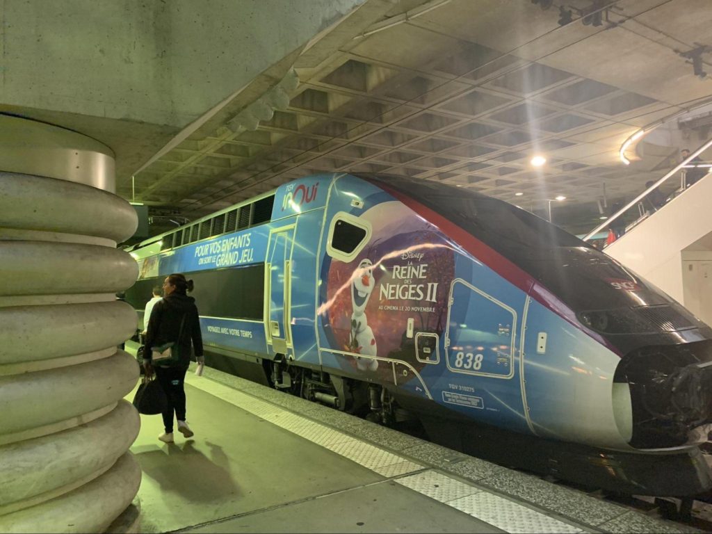 A TGV passenger train parked at a station.